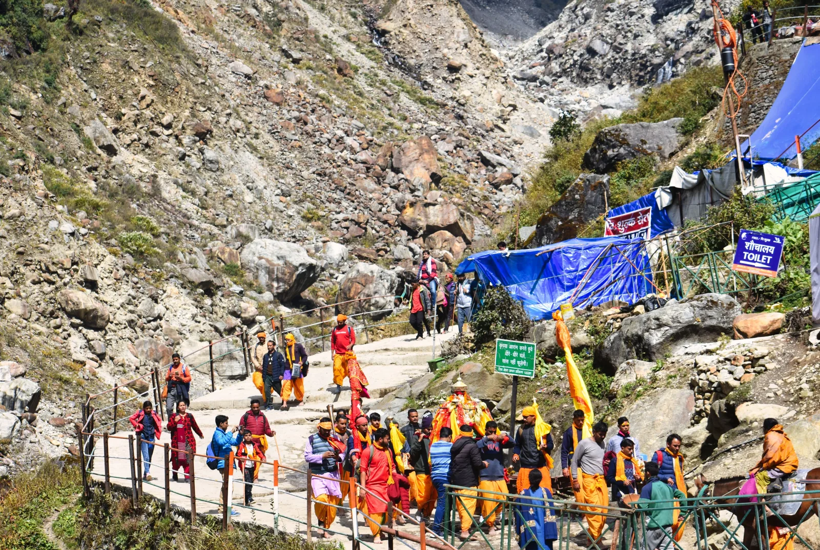 Pilgrims walking a rocky mountain route in Kedarnath