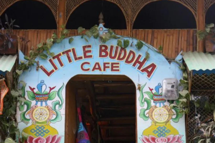 Painted entrance sign at Little Buddha Cafe in Rishikesh