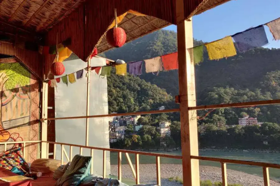 Riverside seating and colourful decor at Shambala Cafe in Rishikesh
